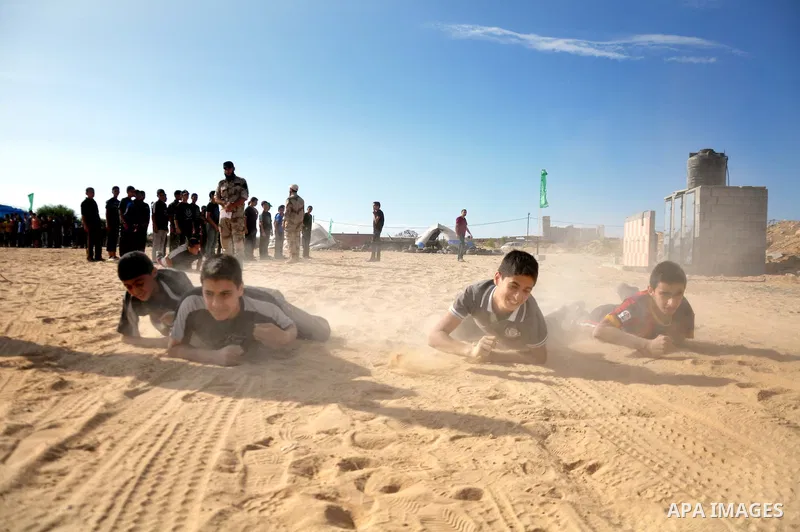 Young Palestinians take part in a military-style exercise at a training course organized by Hamas movement in Gaza City Spe. 28, 2014. Reports said that Hamas planning to establish a 'popular army' in Gaza to help in nex...