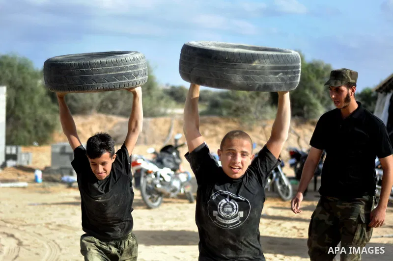 Young Palestinians take part in a military-style exercise at a training course organized by Hamas movement in Gaza City Spe. 28, 2014. Reports said that Hamas planning to establish a 'popular army' in Gaza to help in nex...