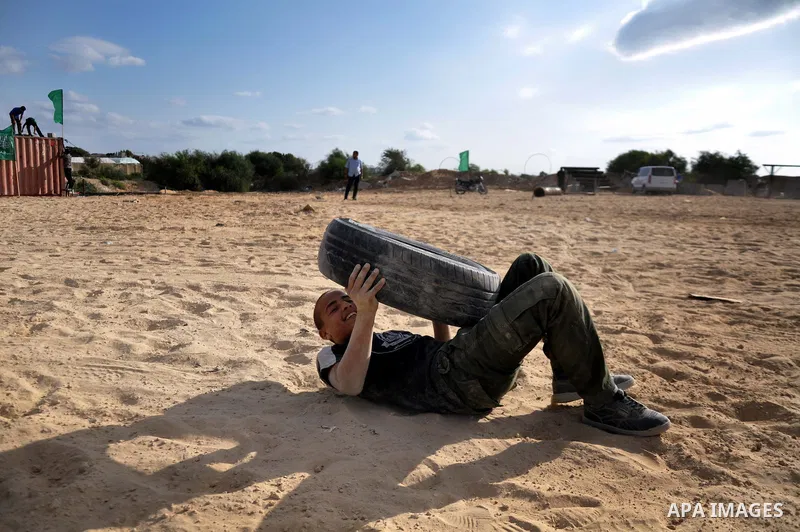 A young Palestinian takes part in a military-style exercise at a training course organized by Hamas movement in Gaza City Spe. 28, 2014. Reports said that Hamas planning to establish a 'popular army' in Gaza to help in n...