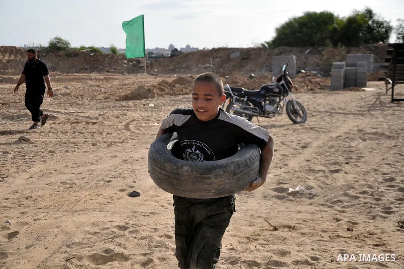 A young Palestinian takes part in a military-style exercise at a training course organized by Hamas movement in Gaza City Spe. 28, 2014. Reports said that Hamas planning to establish a 'popular army' in Gaza to help in n...