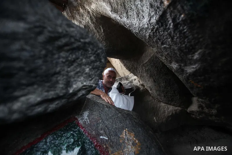 A Muslim pilgrim prays at the Hera cave on Mount Al-Noor during the annual haj pilgrimage in Mecca, on September 29, 2014, Mount Al-Noor houses Ghar-E-Hira or Hira cave, where Prophet Mohammad is said to have spent a gre...