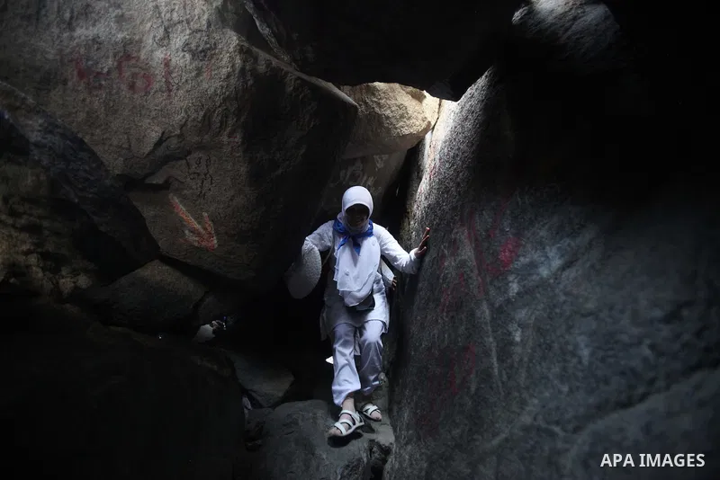 A Muslim pilgrim prays at the Hera cave on Mount Al-Noor during the annual haj pilgrimage in Mecca, on September 29, 2014, Mount Al-Noor houses Ghar-E-Hira or Hira cave, where Prophet Mohammad is said to have spent a gre...