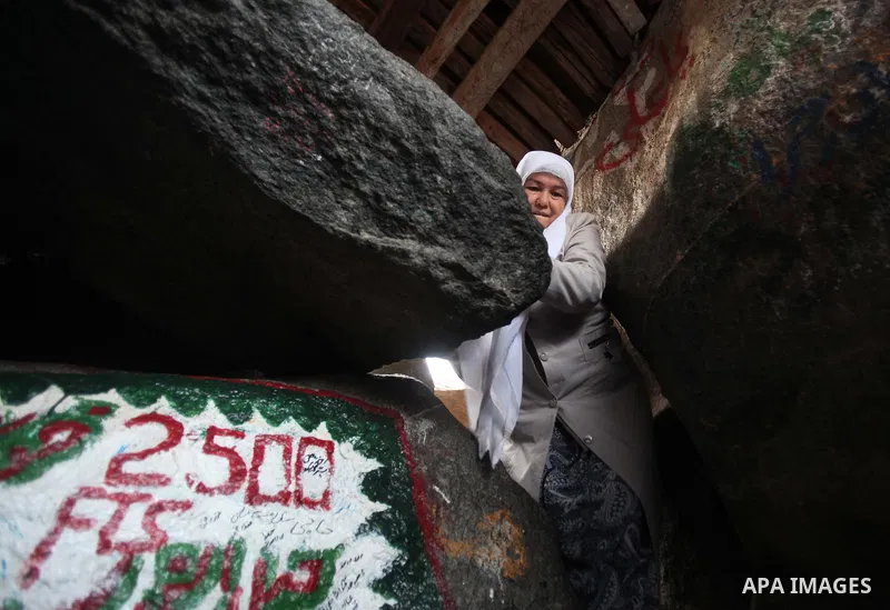 A Muslim pilgrim prays at the entrance of Hera cave on Mount Al-Noor during the annual haj pilgrimage in Mecca, on September 29, 2014, Mount Al-Noor houses Ghar-E-Hira or Hira cave, where Prophet Mohammad is said to have...