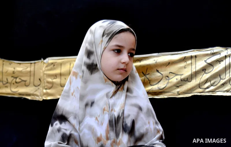 Palestinian children gather around a makeshift cube representing the holy Kaaba in Gaza city, on Sept. 30, 2014, as part of training children how to perform Hajj pilgrimage. Muslims from around the world flood Saudi city...