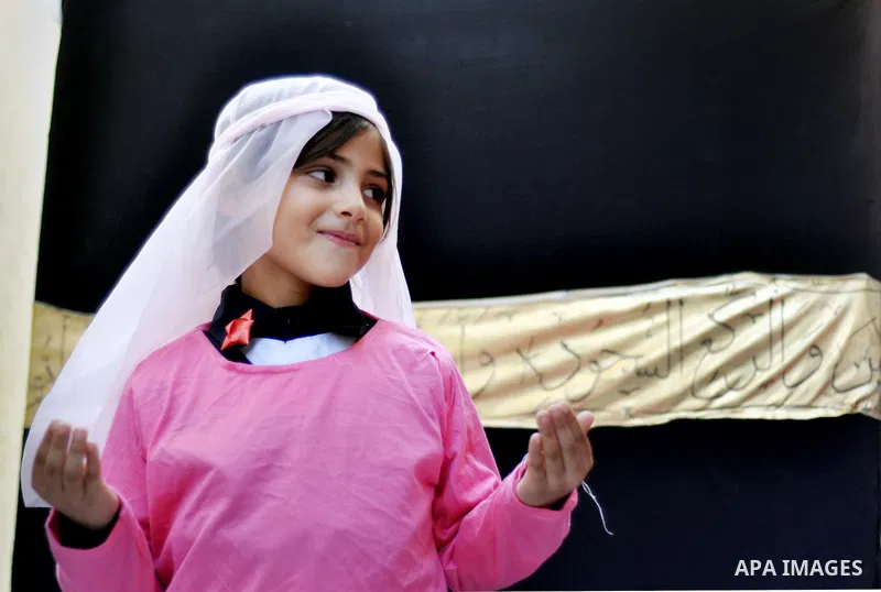 Palestinian children gather around a makeshift cube representing the holy Kaaba in Gaza city, on Sept. 30, 2014, as part of training children how to perform Hajj pilgrimage. Muslims from around the world flood Saudi city...