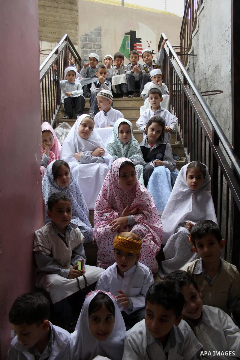 Palestinian children gather around a makeshift cube representing the holy Kaaba in the West Bank city of Nablus, on Sept. 30, 2014, as part of training children how to perform Hajj pilgrimage. Muslims from around the wor...