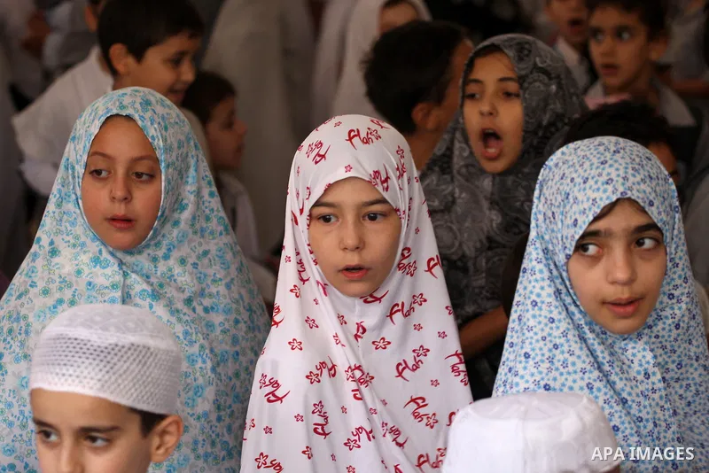 Palestinian children gather around a makeshift cube representing the holy Kaaba in the West Bank city of Nablus, on Sept. 30, 2014, as part of training children how to perform Hajj pilgrimage. Muslims from around the wor...