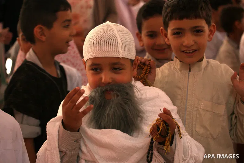 Palestinian children gather around a makeshift cube representing the holy Kaaba in the West Bank city of Nablus, on Sept. 30, 2014, as part of training children how to perform Hajj pilgrimage. Muslims from around the wor...