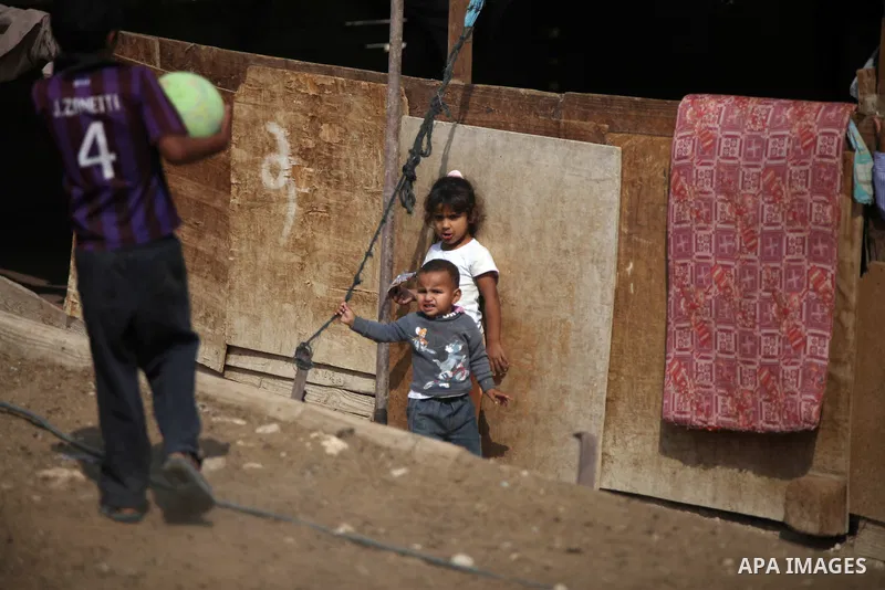 Palestinian Bedouin children play at their family's dwellings, in the West Bank village of Al-Eizariya, near east of Jerusalem, on Septemper 30, 2014. Israel's Civil Administration in the West Bank is advancing a plan to...