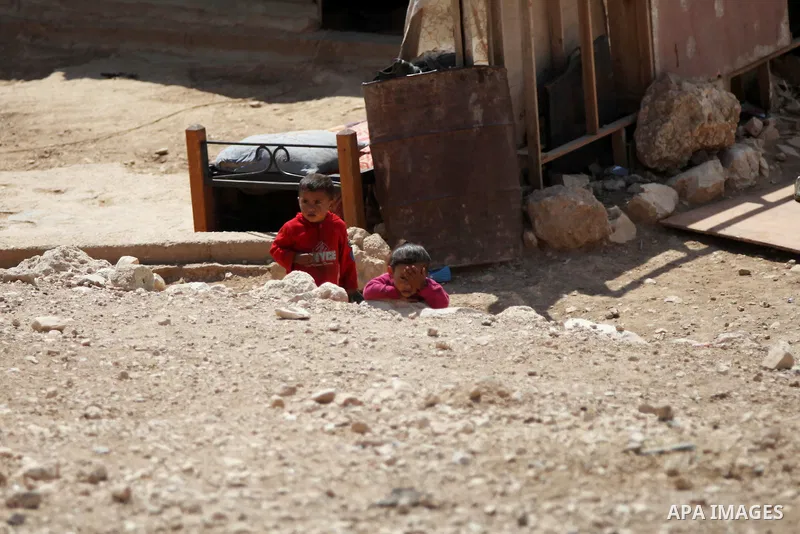 A Palestinian Bedouin boy plays at his family's dwellings, in the West Bank village of Al-Eizariya, near east of Jerusalem, on Septemper 30, 2014. Israel's Civil Administration in the West Bank is advancing a plan to exp...