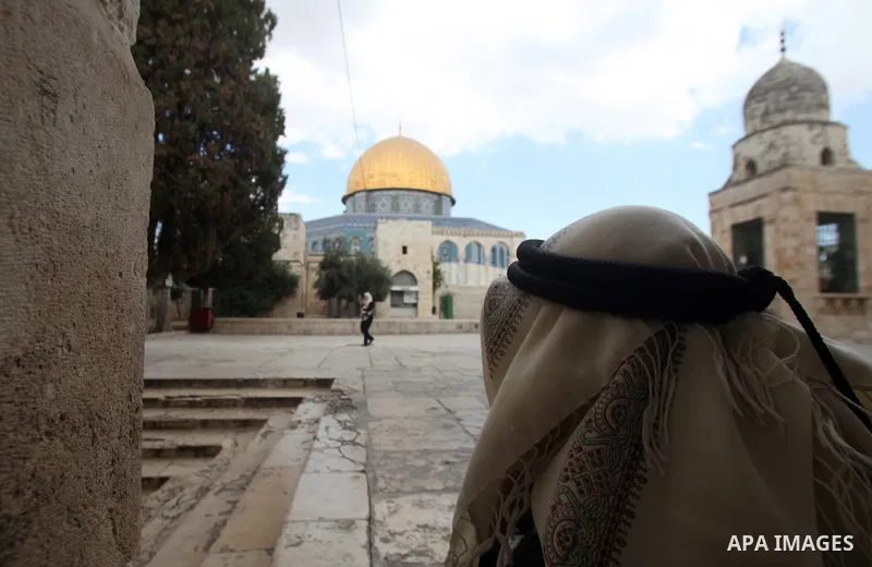 A Palestinian man walks in front of the Dome of the Rock mosque at the al-Aqsa mosque compound in Jerusalem, Sept. 30, 2014. Muslims worldwide are celebrating Eid al-Adha, or Feast of the Sacrifice, commemorating God's p...