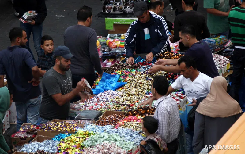 Palestinians shop at a street market two days before the major Muslim festival of Eid al-Adha, in the West Bank city of Ramallah on October 02, 2014. During the first week of October, Muslims across the world will celebr...