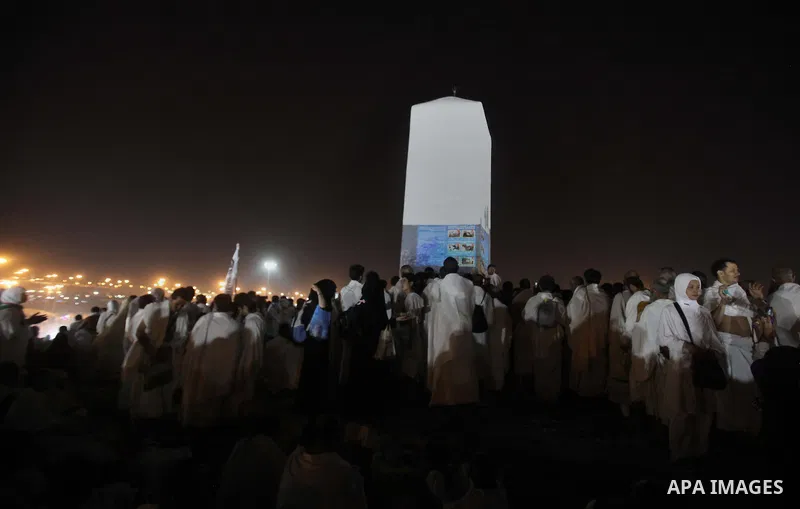 Muslim pilgrims touch a rock as they pray on Mount Arafat, near Mecca, as they take part in one of the Hajj rituals on October 3, 2014. The pilgrims perform a series of rituals during the annual Hajj. They circumambulate...