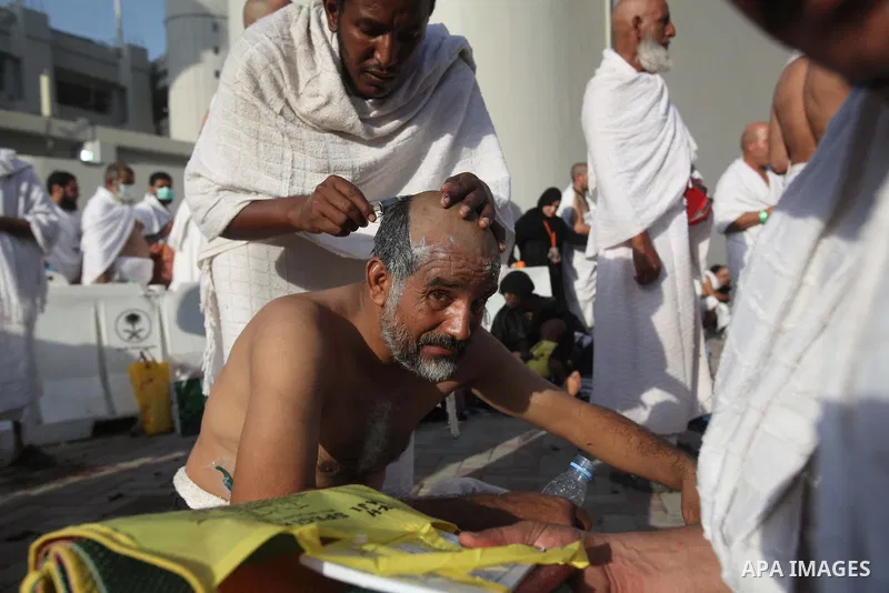 A Muslim pilgrim cuts his hair in celebration of the start of Eid al-Adha in Mina, near the holy city of Mecca on October 04, 2014. The pilgrims perform a series of rituals during the annual Hajj. They circumambulate the...