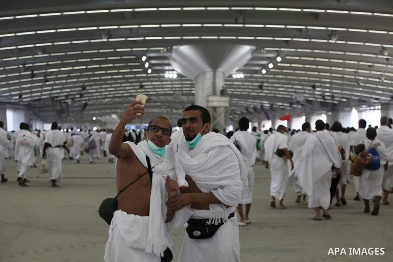 Muslim pilgrims walk to cast stones at a pillar, symbolizing the stoning of Satan, in a ritual called "Jamarat," a rite of the annual hajj, in Mina near the holy city of Mecca on October 04, 2014. The pilgrims perform a...