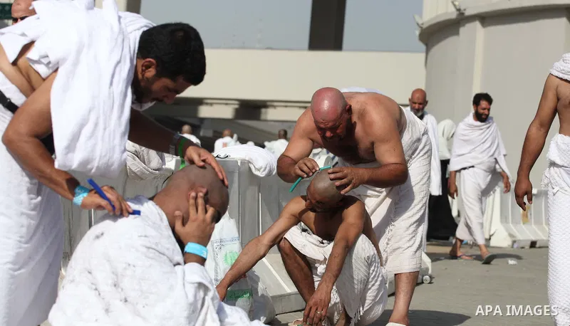 Muslim pilgrims cut their hairs in celebration of the start of Eid al-Adha in Mina, near the holy city of Mecca on October 04, 2014. The pilgrims perform a series of rituals during the annual Hajj. They circumambulate th...