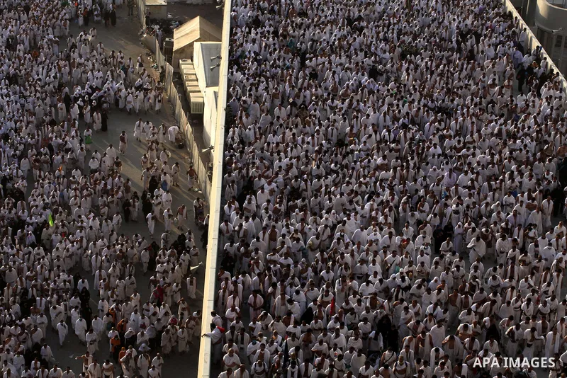 Muslim pilgrims walk to cast stones at a pillar, symbolizing the stoning of Satan, in a ritual called "Jamarat," a rite of the annual hajj, in Mina near the holy city of Mecca on October 04, 2014. The pilgrims perform a...