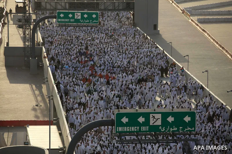 Muslim pilgrims walk to cast stones at a pillar, symbolizing the stoning of Satan, in a ritual called "Jamarat," a rite of the annual hajj, in Mina near the holy city of Mecca on October 04, 2014. The pilgrims perform a...