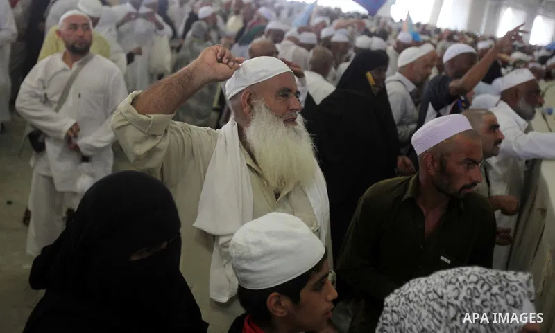 Muslim pilgrims walk to cast stones at a pillar, symbolizing the stoning of Satan, in a ritual called "Jamarat," a rite of the annual hajj, in Mina near the holy city of Mecca on October 05, 2014. The pilgrims perform a...