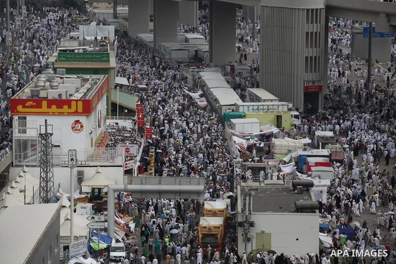 Muslim pilgrims walk to cast stones at a pillar, symbolizing the stoning of Satan, in a ritual called "Jamarat," a rite of the annual hajj, in Mina near the holy city of Mecca on October 05, 2014. The pilgrims perform a...