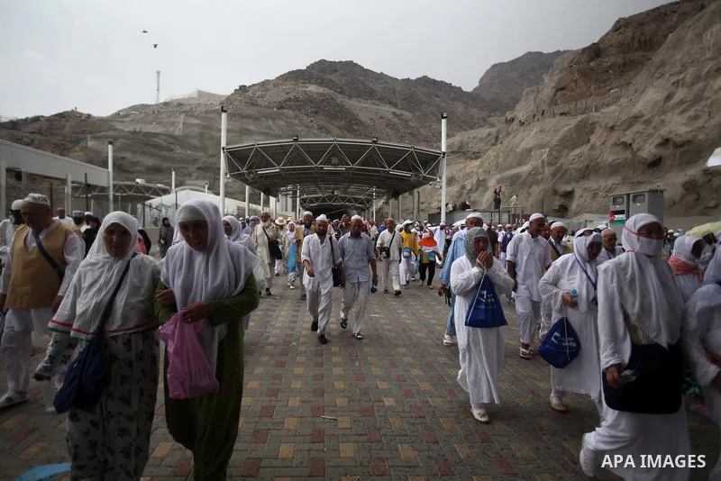 Muslim pilgrims walk to cast stones at a pillar, symbolizing the stoning of Satan, in a ritual called "Jamarat," a rite of the annual hajj, in Mina near the holy city of Mecca on October 05, 2014. The pilgrims perform a...