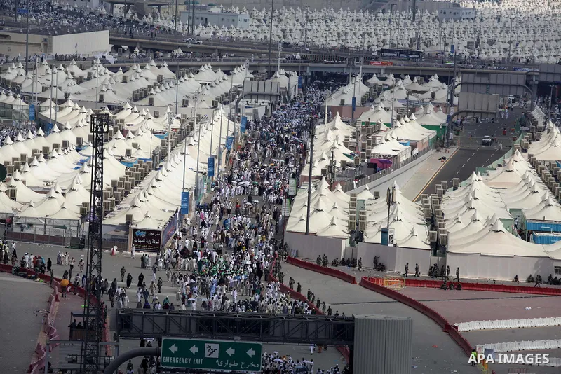 Muslim pilgrims walk to cast stones at a pillar, symbolizing the stoning of Satan, in a ritual called "Jamarat," a rite of the annual hajj, in Mina near the holy city of Mecca on October 05, 2014. The pilgrims perform a...