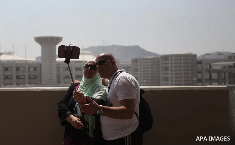Muslim pilgrims take a photo "Selfie" after they cast stones at a pillar, symbolizing the stoning of Satan, in a ritual called "Jamarat," a rite of the annual hajj, in Mina near the holy city of Mecca on October 06, 2014...