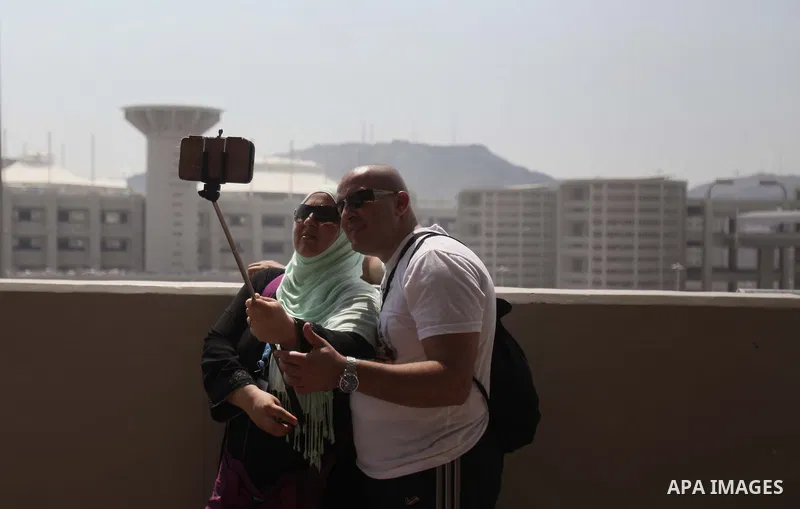 Muslim pilgrims take a photo "Selfie" after they cast stones at a pillar, symbolizing the stoning of Satan, in a ritual called "Jamarat," a rite of the annual hajj, in Mina near the holy city of Mecca on October 06, 2014...