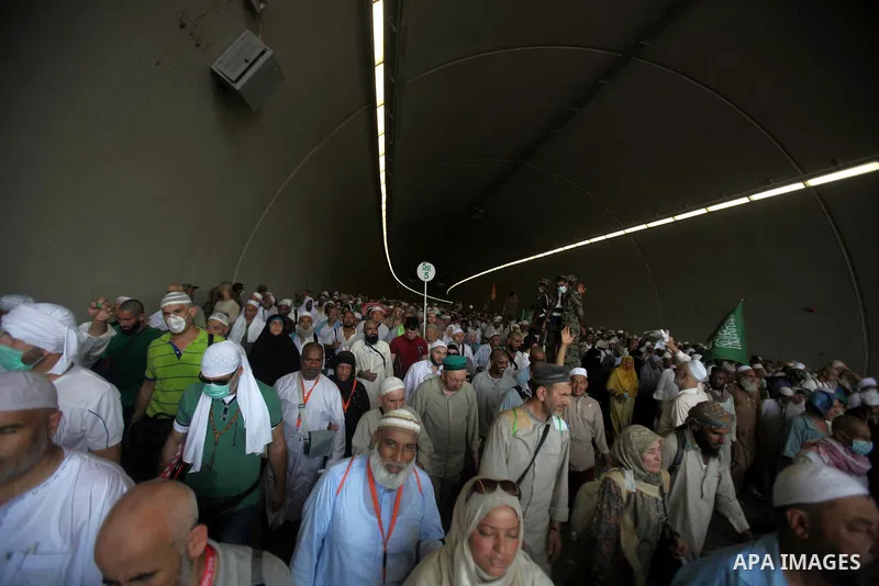 Muslim pilgrims walk to cast stones at a pillar, symbolizing the stoning of Satan, in a ritual called "Jamarat," a rite of the annual hajj, in Mina near the holy city of Mecca on October 06, 2014. The pilgrims perform a...