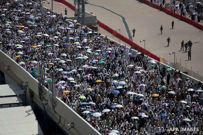 Muslim pilgrims walk to cast stones at a pillar, symbolizing the stoning of Satan, in a ritual called "Jamarat," a rite of the annual hajj, in Mina near the holy city of Mecca on October 06, 2014. The pilgrims perform a...