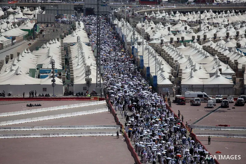 Muslim pilgrims walk to cast stones at a pillar, symbolizing the stoning of Satan, in a ritual called "Jamarat," a rite of the annual hajj, in Mina near the holy city of Mecca on October 06, 2014. The pilgrims perform a...
