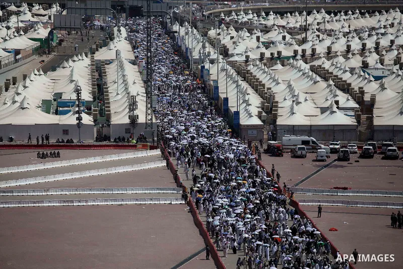 Muslim pilgrims walk to cast stones at a pillar, symbolizing the stoning of Satan, in a ritual called "Jamarat," a rite of the annual hajj, in Mina near the holy city of Mecca on October 06, 2014. The pilgrims perform a...