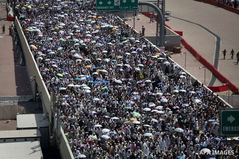 Muslim pilgrims walk to cast stones at a pillar, symbolizing the stoning of Satan, in a ritual called "Jamarat," a rite of the annual hajj, in Mina near the holy city of Mecca on October 06, 2014. The pilgrims perform a...