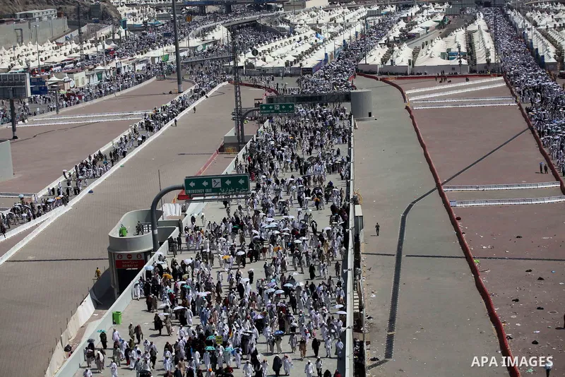 Muslim pilgrims walk to cast stones at a pillar, symbolizing the stoning of Satan, in a ritual called "Jamarat," a rite of the annual hajj, in Mina near the holy city of Mecca on October 06, 2014. The pilgrims perform a...