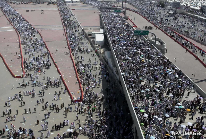 Muslim pilgrims walk to cast stones at a pillar, symbolizing the stoning of Satan, in a ritual called "Jamarat," a rite of the annual hajj, in Mina near the holy city of Mecca on October 06, 2014. The pilgrims perform a...