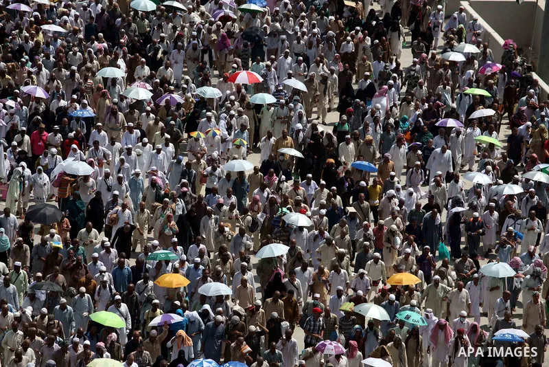 Muslim pilgrims walk to cast stones at a pillar, symbolizing the stoning of Satan, in a ritual called "Jamarat," a rite of the annual hajj, in Mina near the holy city of Mecca on October 06, 2014. The pilgrims perform a...