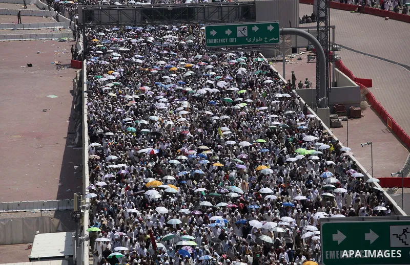 Muslim pilgrims walk to cast stones at a pillar, symbolizing the stoning of Satan, in a ritual called "Jamarat," a rite of the annual hajj, in Mina near the holy city of Mecca on October 06, 2014. The pilgrims perform a...