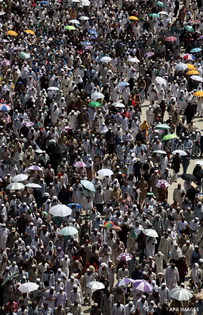 Muslim pilgrims walk to cast stones at a pillar, symbolizing the stoning of Satan, in a ritual called "Jamarat," a rite of the annual hajj, in Mina near the holy city of Mecca on October 06, 2014. The pilgrims perform a...