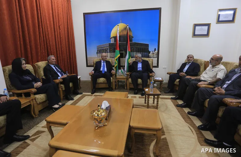 Palestinian Prime Minister Rami Hamdallah meets with senior Hamas leader Ismail Haniyeh, at Haniyeh's house in Gaza city on October 9, 2014. The Palestinian unity government which took the oath of office in June under te...