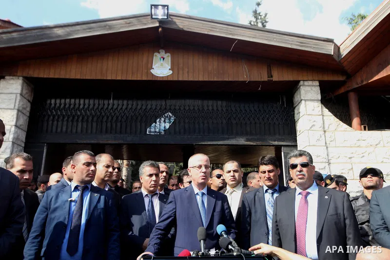 Palestinian Prime Minister Rami Hamdallah holds a press conference after headed the cabinet session in the Abbas's former official resident in Gaza City on October 9, 2014. The Palestinian unity government which took the...
