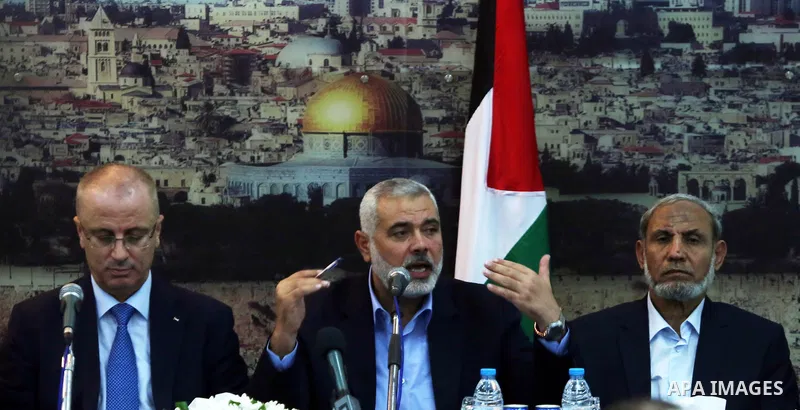 Senior Hamas leader Ismail Haniyeh speaks during the visit of Palestinian Prime Minister Rami Hamdallah, at Haniyeh's house in Gaza city on October 9, 2014. The Palestinian unity government which took the oath of office...