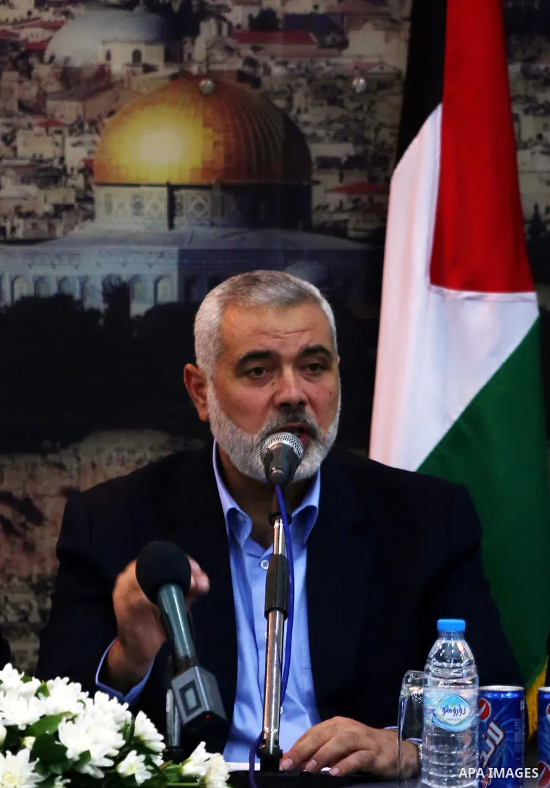 Senior Hamas leader Ismail Haniyeh speaks during the visit of Palestinian Prime Minister Rami Hamdallah, at Haniyeh's house in Gaza city on October 9, 2014. The Palestinian unity government which took the oath of office...