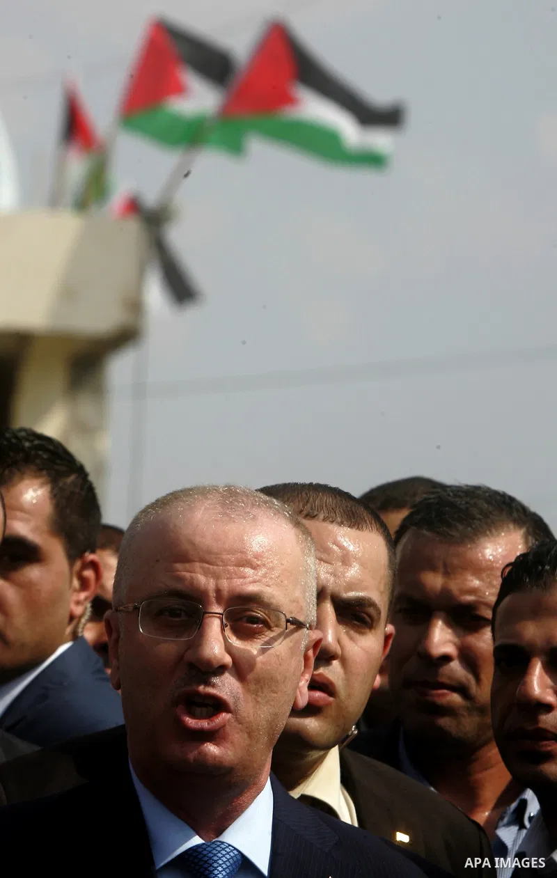 Palestinian Prime Minister Rami Hamdallah speaks to media upon his arrival to the Beit Hanoun in the northern Gaza Strip on October 9, 2014. The Palestinian unity government which took the oath of office in June under te...
