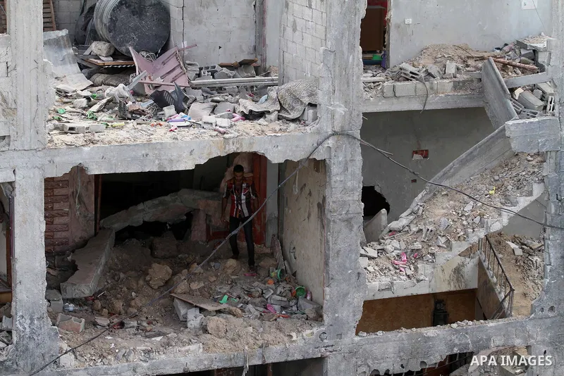 A Palestinian man collects belongings from the rubble of his house that was destroyed during the devastating 50-day war between Israel and Hamas at Al-Shojae'ya neighborhood east of Gaza City on October 12, 2014. Ahead o...