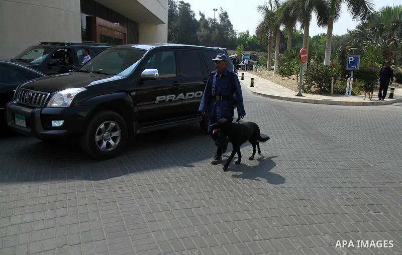An Egyptian security officer walks with his dog as representatives of donor countries attend the opening session of the Gaza Donor Conference in Cairo on October 12, 2014, aimed at helping the Gaza Strip pummelled by the...