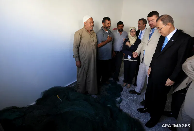 United Nations (UN) Secretary General Ban Ki-moon meets with Palestinian fishermen at the UN fishermen project, in Gaza City on October 14, 2014. The UN chief's visit to the Gaza Strip came a day after a Cairo conference...