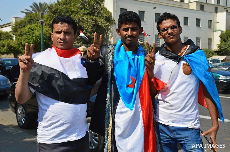 Members of Southern Yemeni community in Egypt hold their national flags as they protest outside the Arab league headquarters demanding that the formerly independent South secede as they celebrated the anniversary of the...