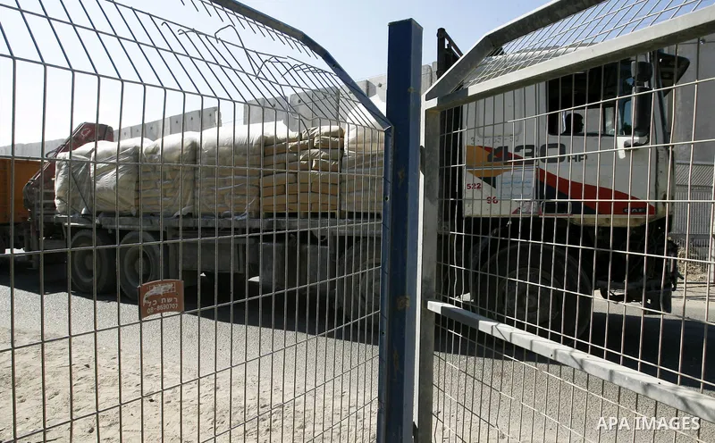 Trucks loaded with bags of cement enter the Gaza Strip from Israel through the Kerem Shalom crossing, in Rafah in southern Gaza on October 14, 2014. International donors pledged about $5.4 billion in aid to the devastate...