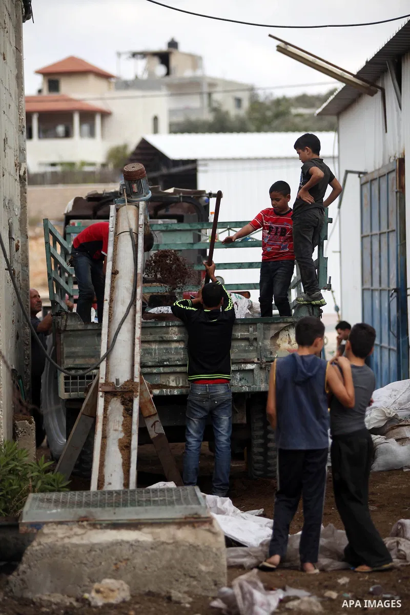 Palestinians prepare their olives to crush at a traditional stone press in the village of Deir Bzeigh near the West Bank city of Ramallah, 15 October 2014. Regional farmers are harvesting their olives this year from mid-...