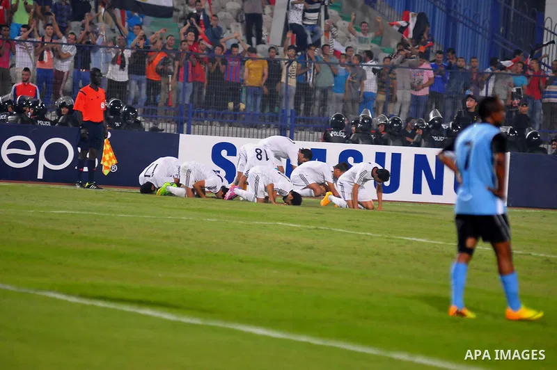 Egyptian players compete against with Botswana players during the qualifying match of 2015 Africa Cup soccer match, in Cairo, capital of Egypt, on Oct. 15, 2014. Egypt won the match with 2-0. Photo by Amr Sayed